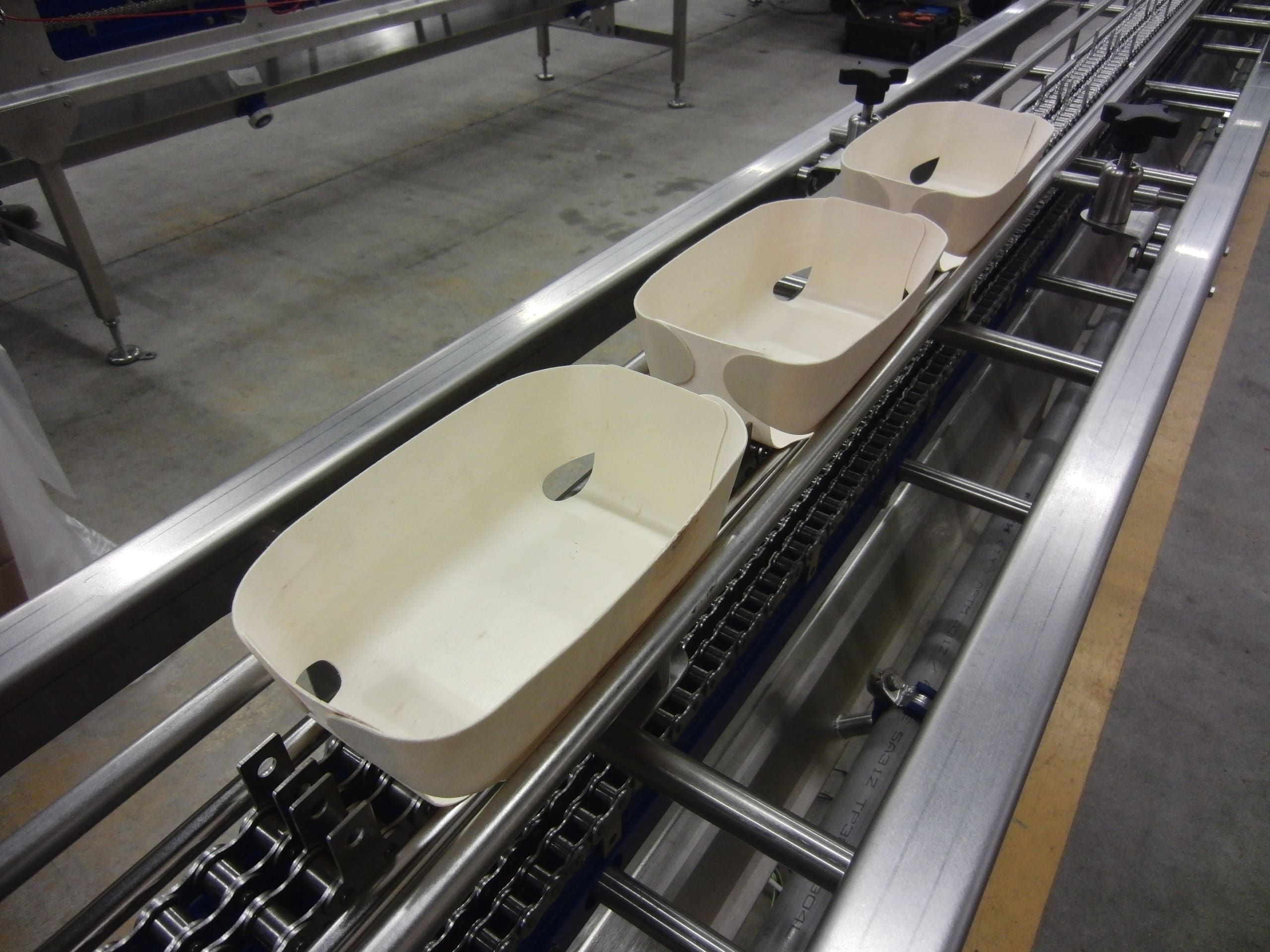 Ready meal trays moving along a WMH production conveyor