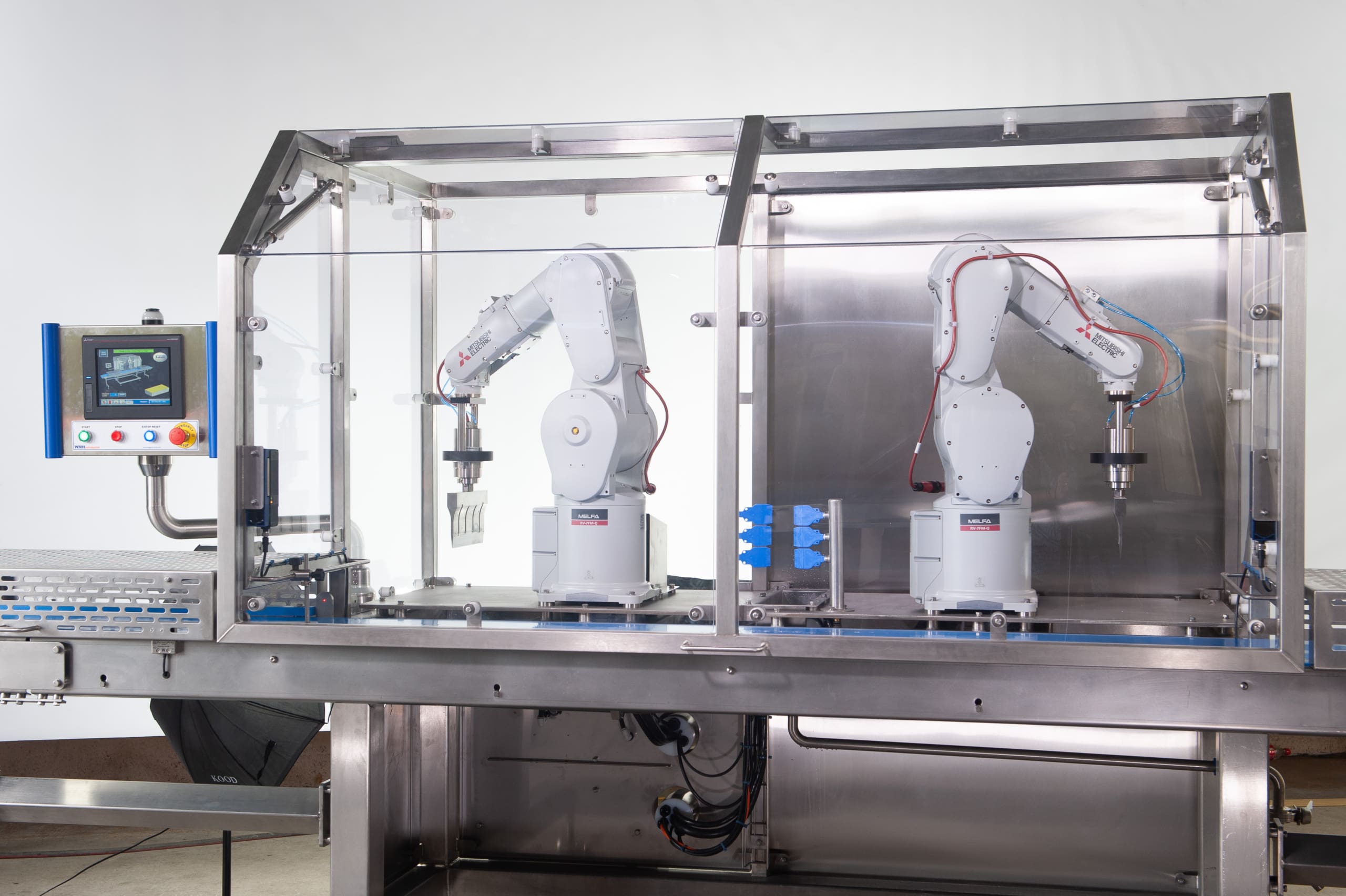 WMH twin robotic ultrasonic cutting system, built with stainless steel guarding and conveyors